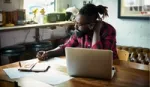 Man with beard working at laptop. Unilever Flex Experience matches people with projects that offer the chance to upskill.