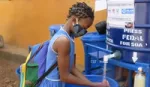 Student girl washing her hands outdoors