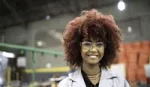 Young woman in lab coat and goggles. Unilever is committed to upskilling young people for ‘future fit’ job opportunities