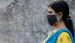 Side Face of an Indian woman wearing homemade cotton nose mask to reduce the spread of Covid-19 – stock photo