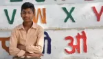 A photograph of Indian schoolboy, Virendra, in his school yard.